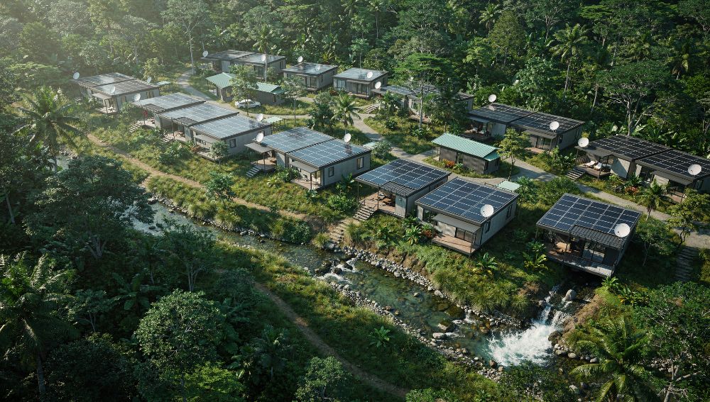 The full village from above, solar roofs along a stream through the canopy